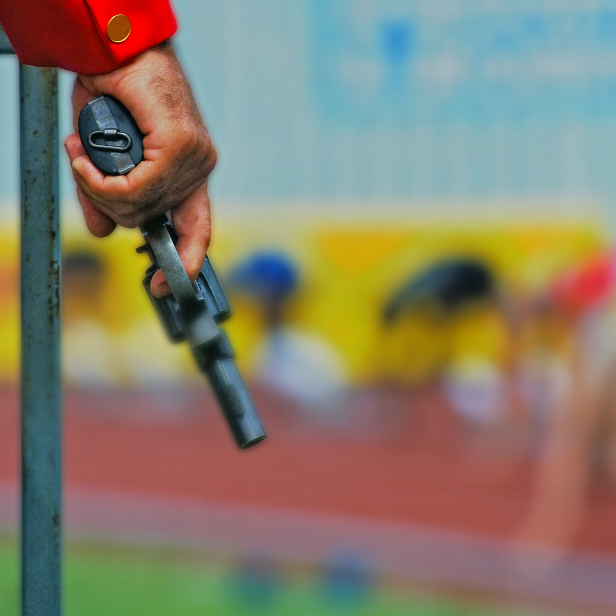 Track race holding blank firing gun in hand